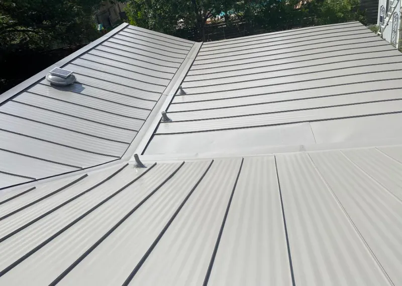 Solar attic fan installed on a metal roof for Roof Ventilation in Flowing Wells